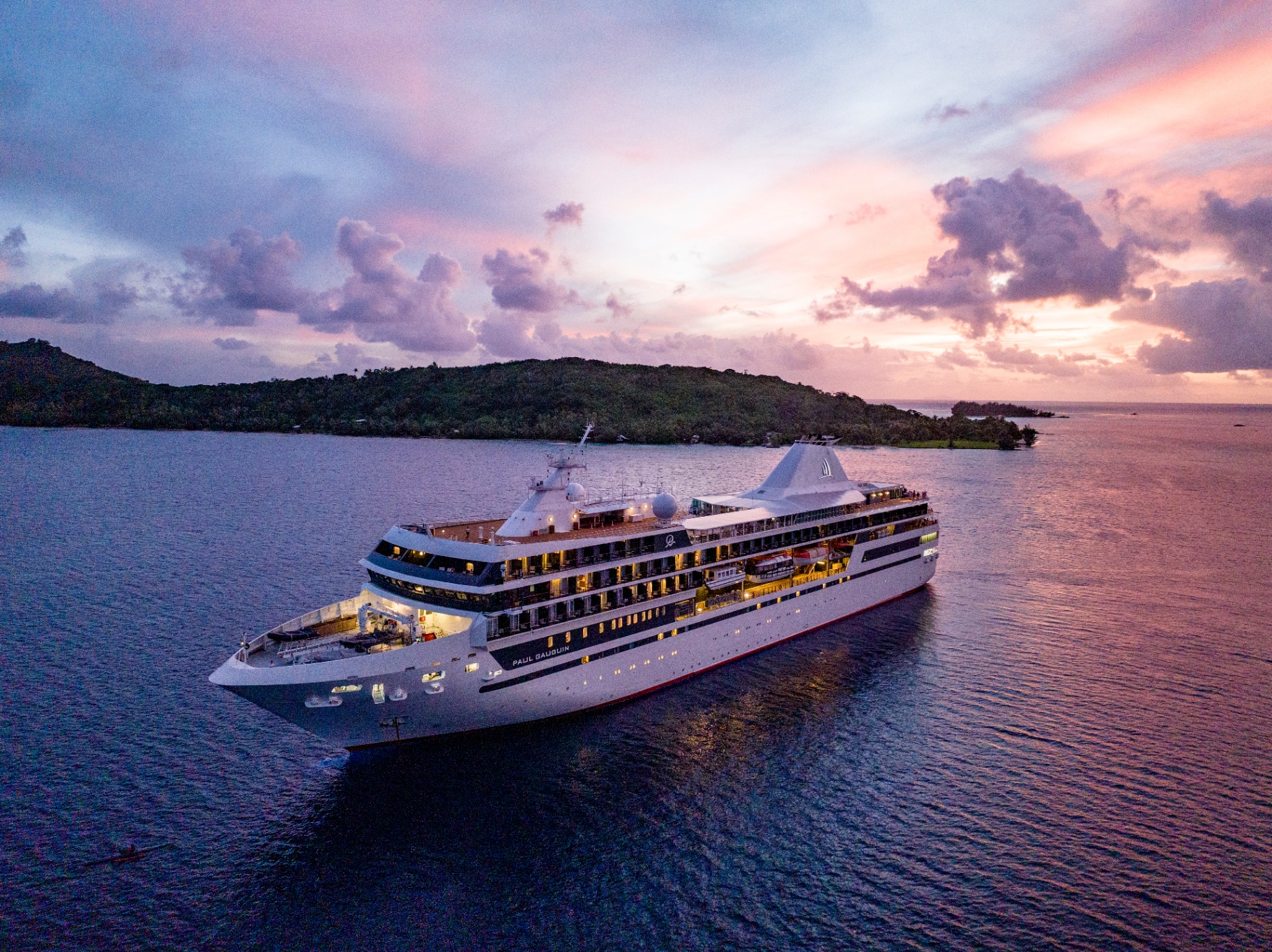 The Paul Gauguin sailing at sunset in Bora Bora