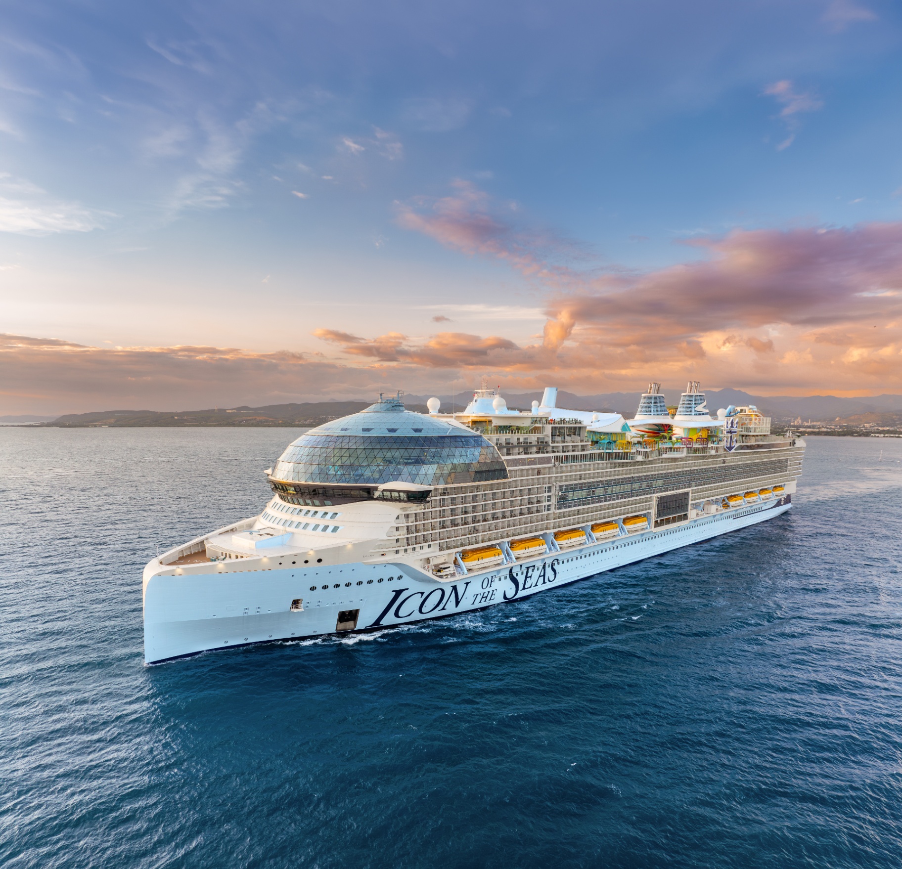 Icon of the Seas sailing at sunset